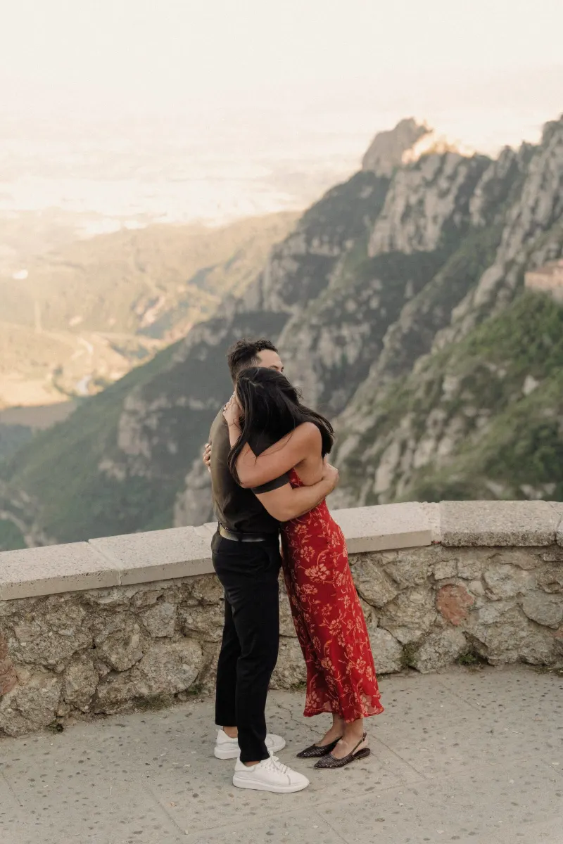 Dan and Sydney share their first embrace as an engaged couple above the Montserrat valley.