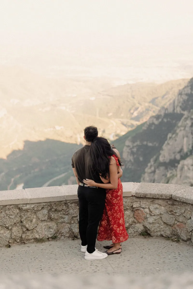 Dan and Sydney stand together at a mountain viewpoint moments before the surprise proposal in Montserrat.