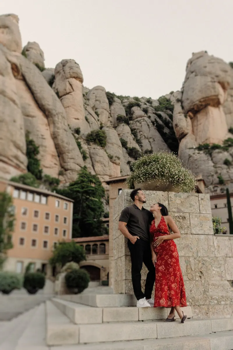 Dan and Sydney stand together beneath the dramatic rock formations of Montserrat.