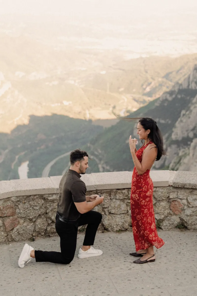 Dan turns toward Sydney at the Montserrat viewpoint as their surprise proposal story begins.