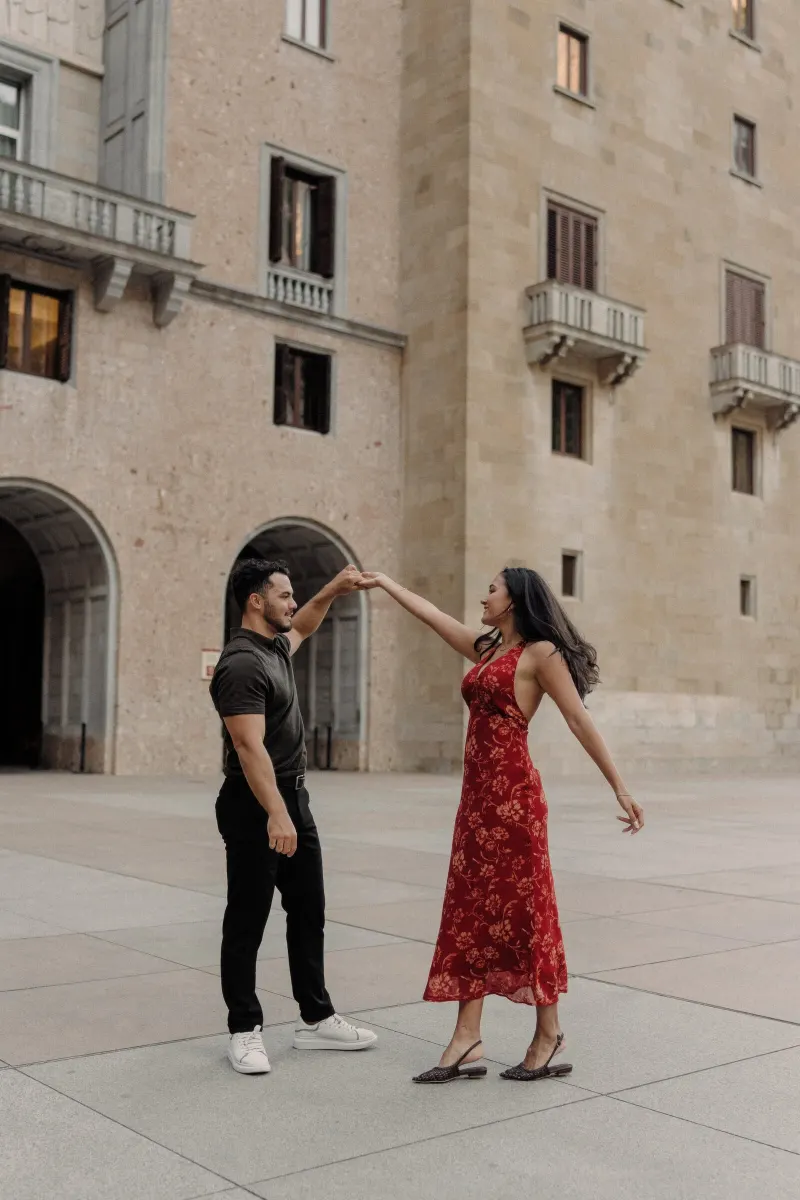 Dan twirls Sydney across the monastery square during their joyful engagement session.