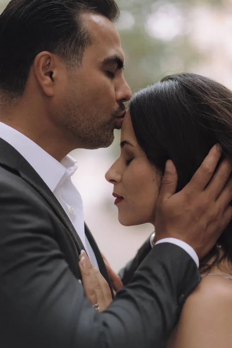 Edgar gently holds Ashley's face during a close and tender couple portrait.