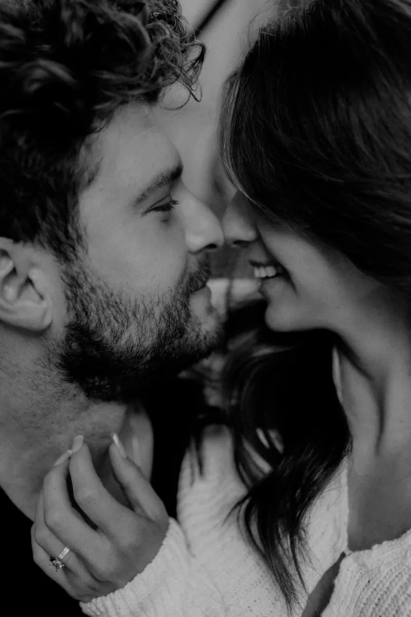 Engaged couple shares an intimate, joyful moment up close, highlighting their connection during a couples photoshoot.