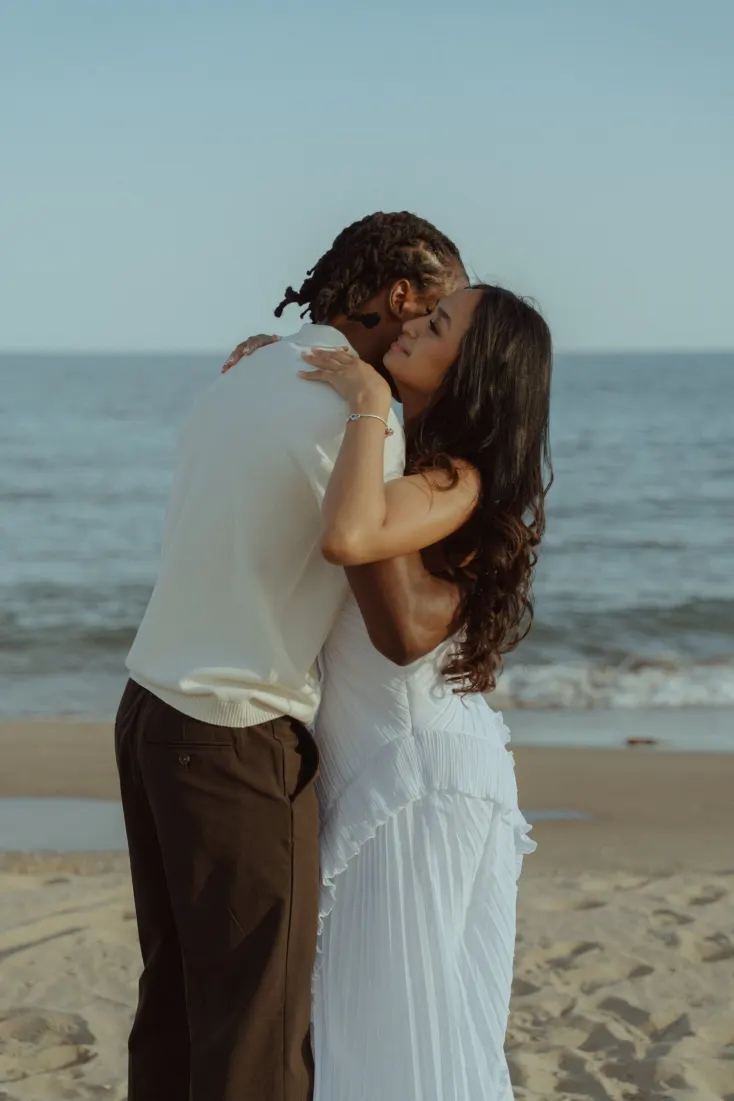 Newly engaged Dexter and Cheryl share an emotional embrace beside the sea at Castelldefels Beach.