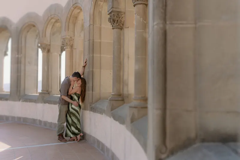Rows of arches frame Tim and Megan embracing in the gallery.