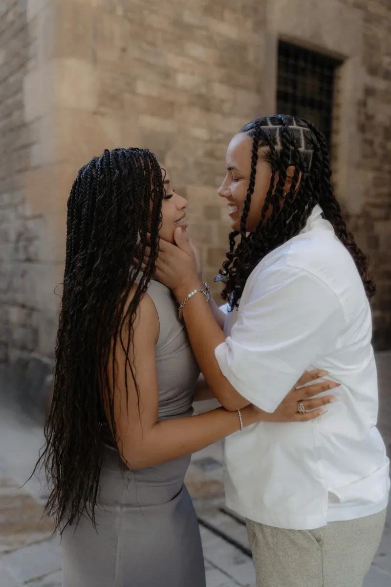 Smiling couple shares a loving, intimate moment during a surprise proposal photoshoot in Barcelona’s Gothic Quarter.