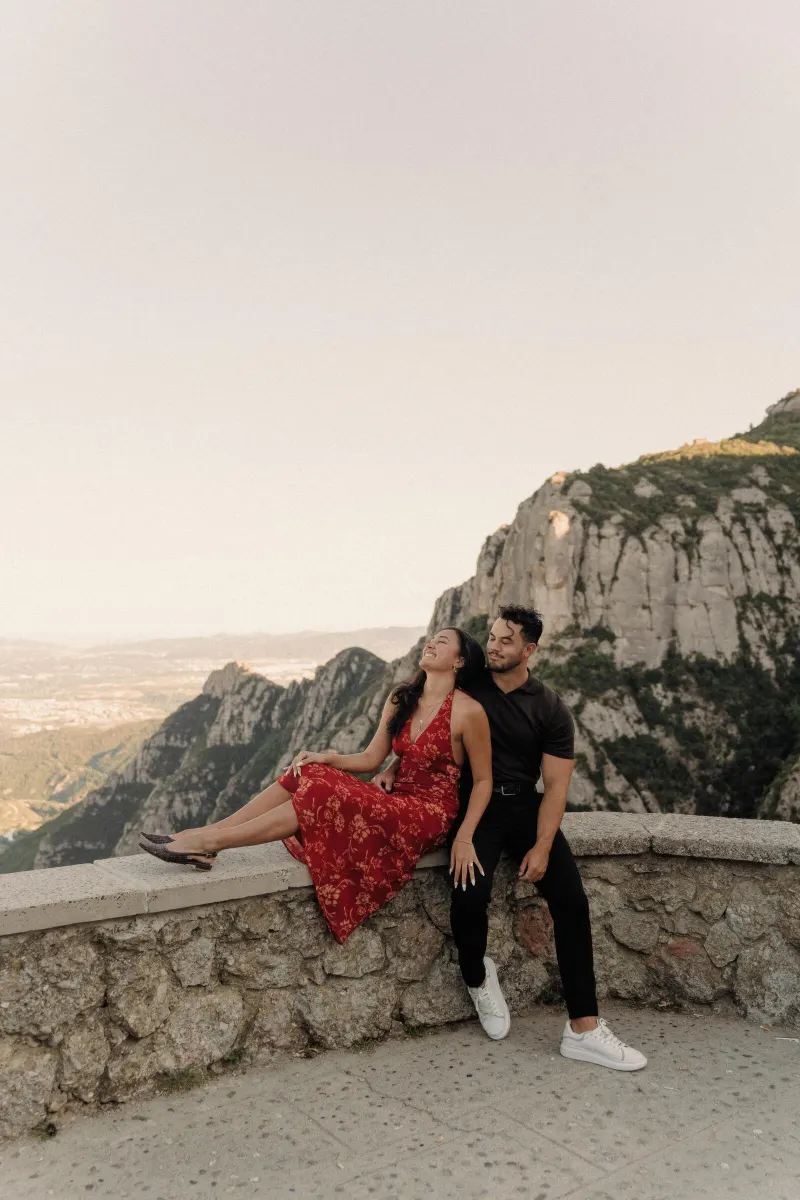 Sydney leans toward Dan during a relaxed engagement portrait above the Montserrat valley.