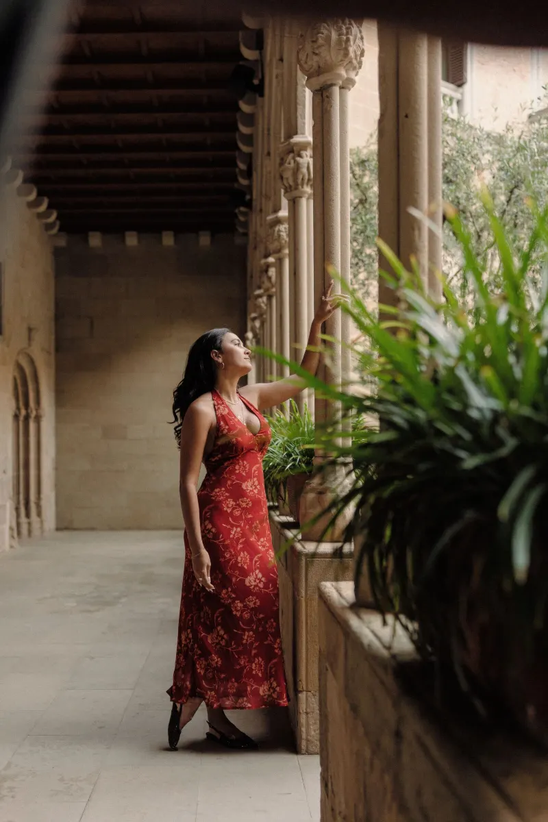 Sydney looks through the cloister garden during her Montserrat engagement session.