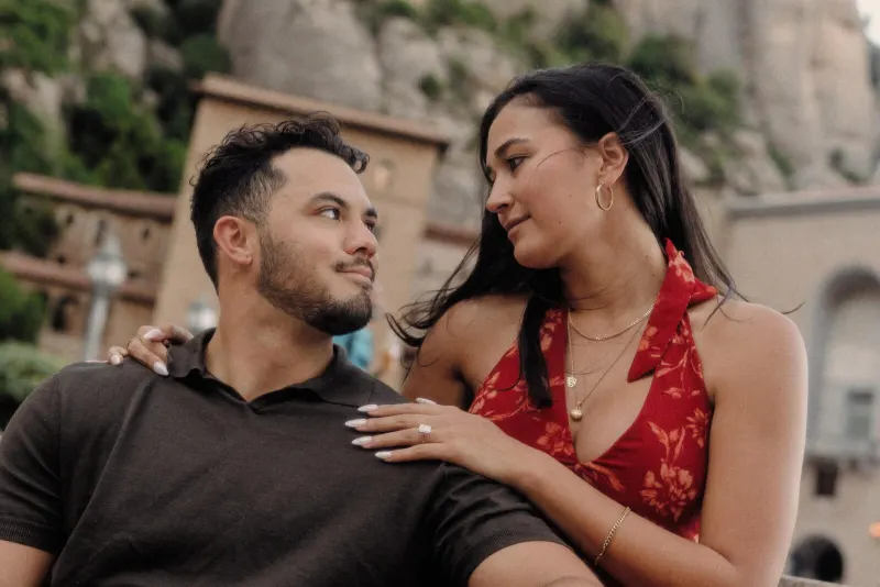 Sydney rests her hand on Dan’s shoulder during a relaxed portrait in the monastery square.
