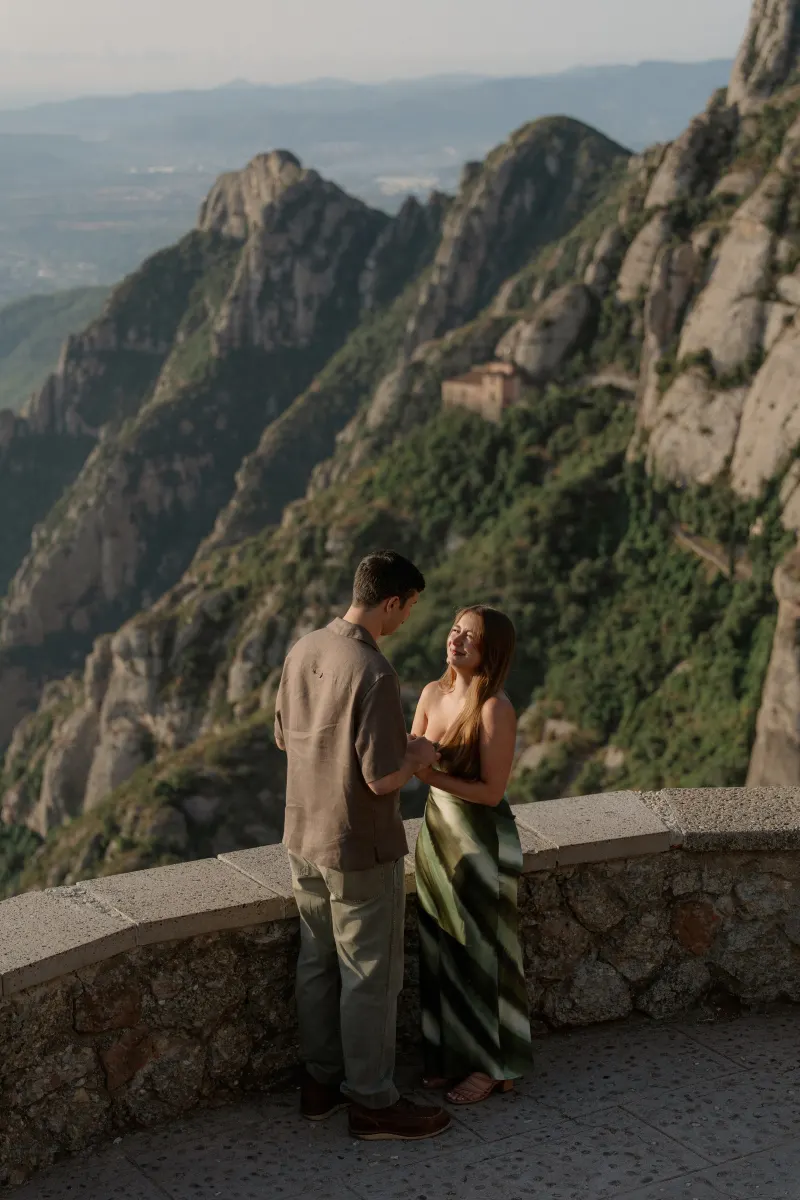 Tim and Megan face each other with Montserrat's rocky slopes behind them.