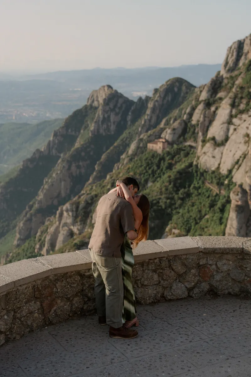 Tim and Megan kiss beside the mountain viewpoint after the proposal.