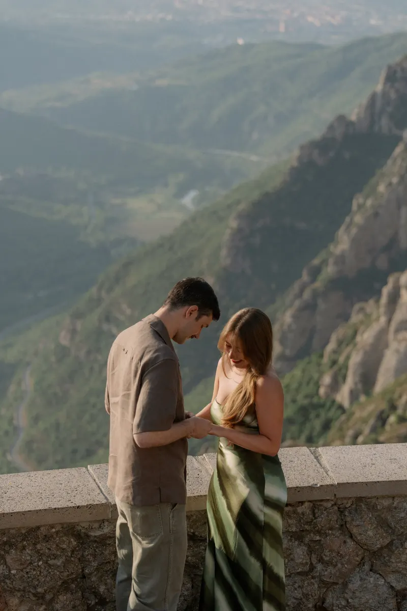 Tim and Megan look down at the ring on her hand.