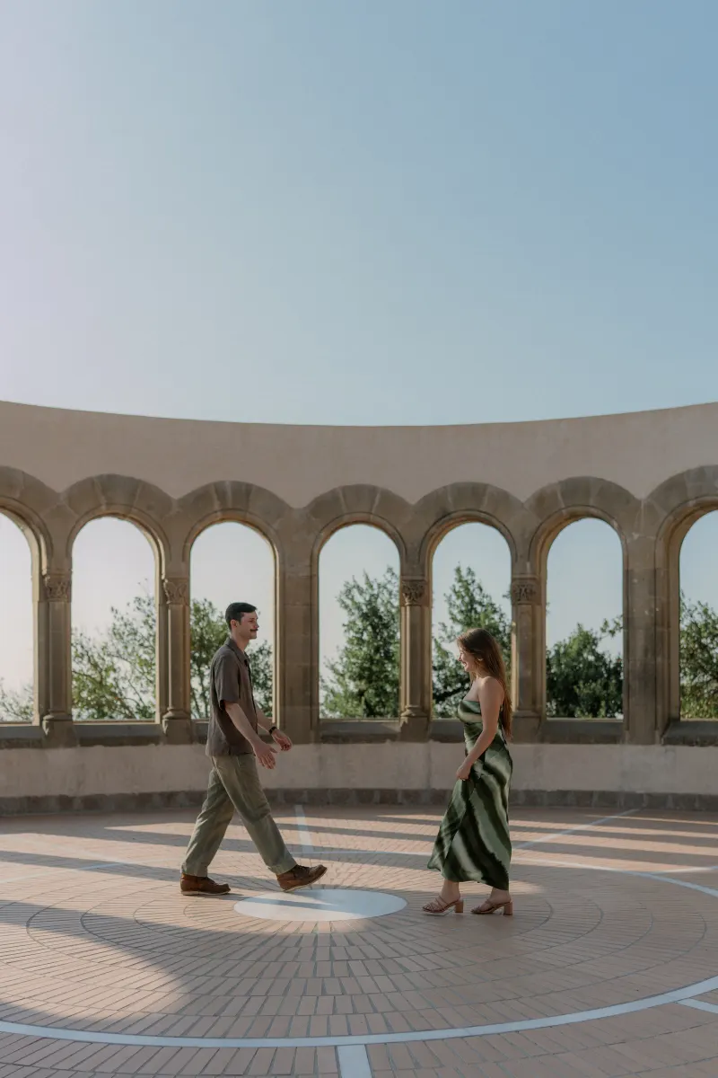 Tim and Megan walk across the gallery's patterned floor.