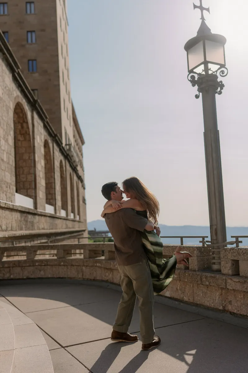 Tim holds Megan as they kiss on the monastery terrace.