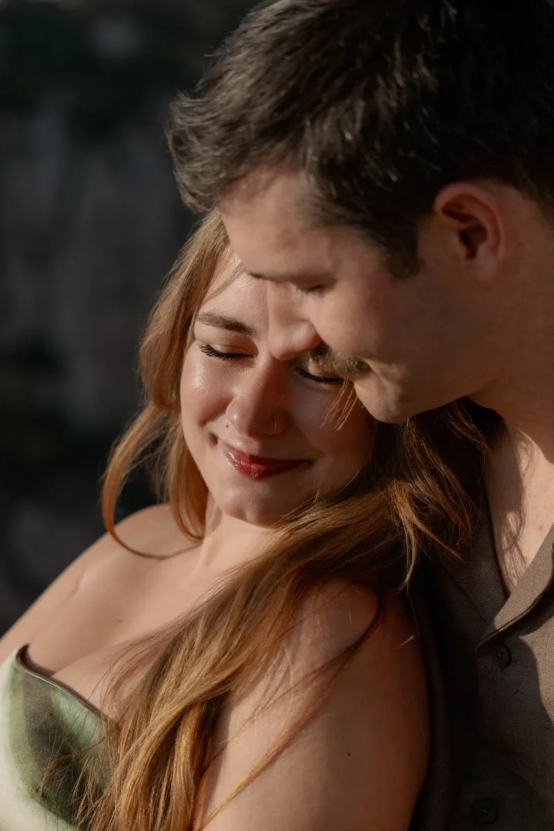 Tim leans his head against Megan in a close embrace.