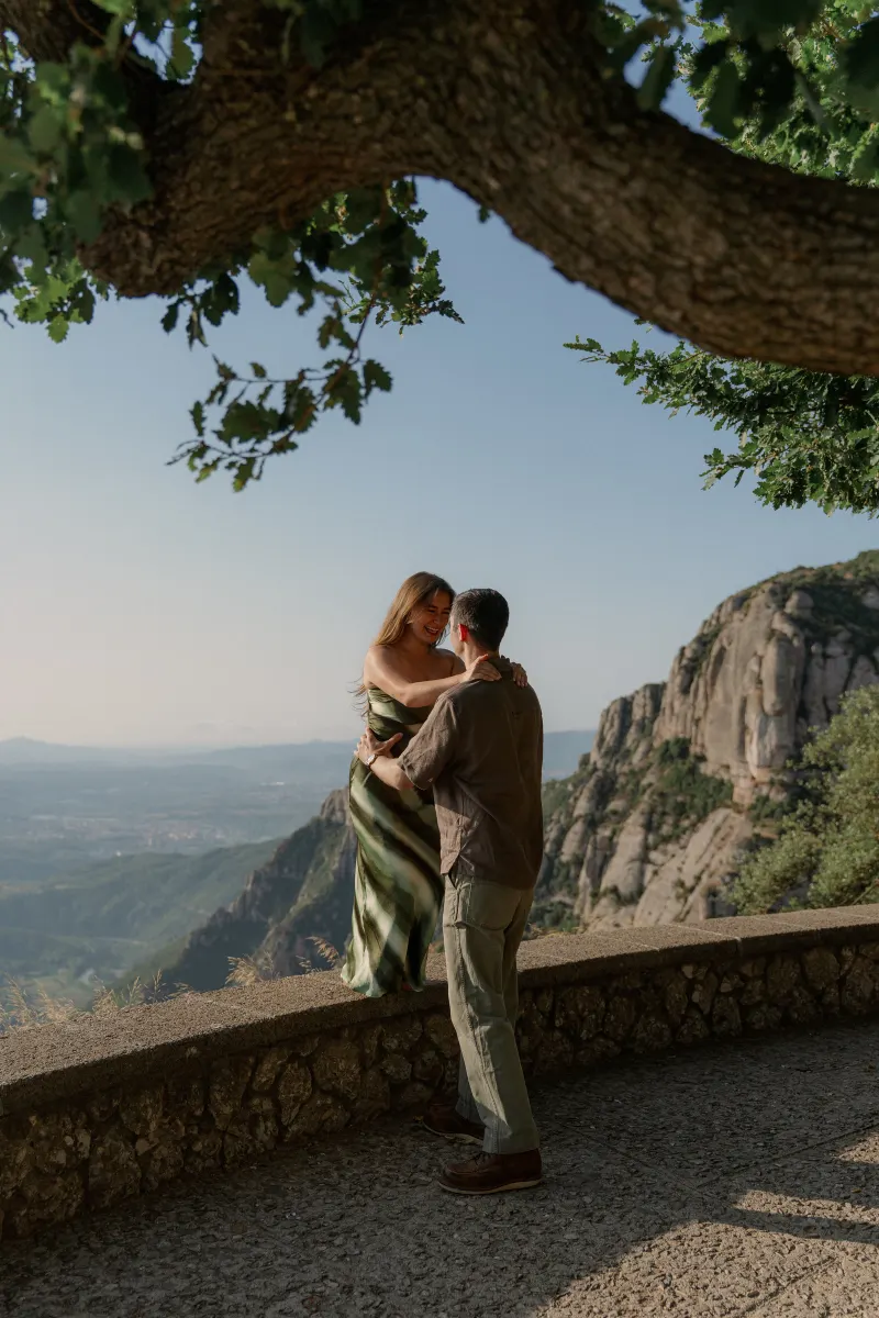 Tim lifts Megan into an embrace beneath the tree.