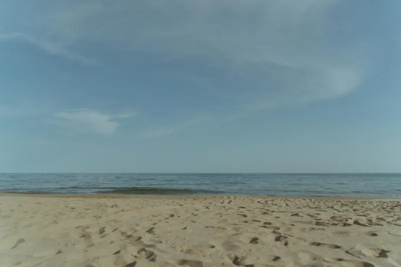 Wide view of Castelldefels Beach in soft evening light before Dexter and Cheryl’s surprise proposal near Barcelona.