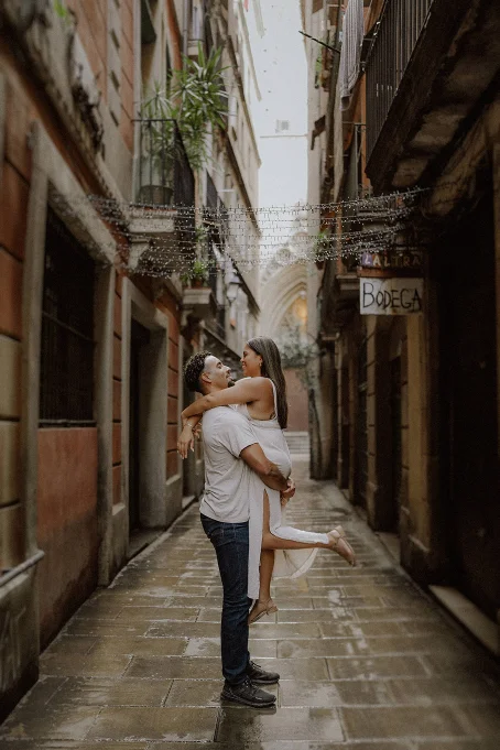 Couple embracing and smiling in a narrow Born area street, captured during a romantic location photography session.