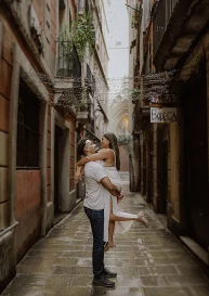 Couple embracing joyfully in a narrow Born area street, perfect for romantic couples photography sessions.
