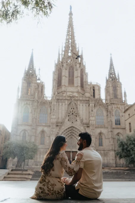 Couple sharing a joyful moment in front of the Gothic quarter cathedral, perfect for romantic location photography sessions.