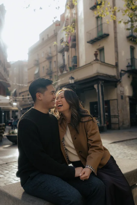Couple sharing a joyful moment on a sunlit street in the Born area, captured during a location portrait session.