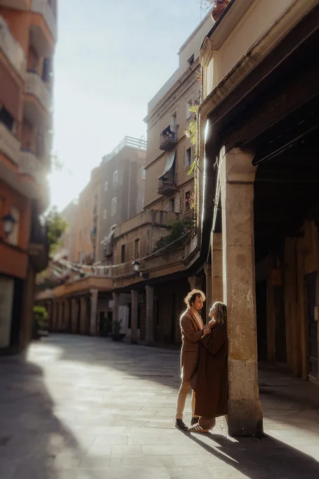 Couple sharing a tender moment in the sunlit streets of Born, perfect for a romantic location photoshoot.