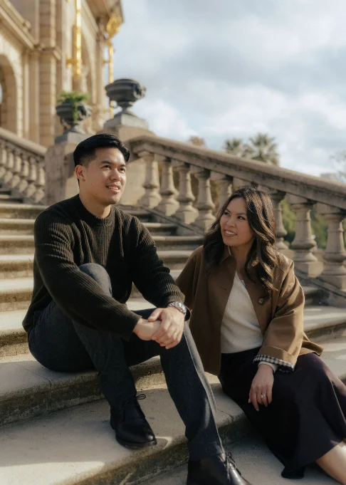 Couple sharing a warm moment on the steps at Park de la Ciutadella, captured during a location portrait session.