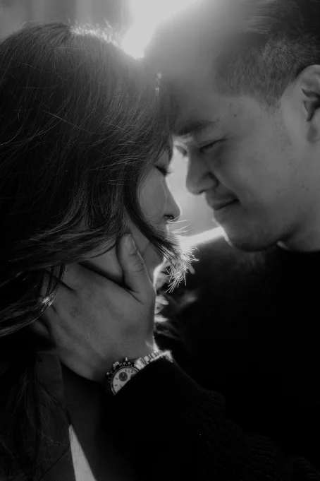 Couple sharing an intimate moment in the Gothic Quarter, captured with soft light by a professional photographer.