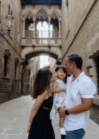 Family shares a tender moment in Barcelona’s Gothic Quarter, perfect for lifestyle and vacation photography sessions.