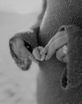 Hands gently holding a seashell at Ginesta beach, capturing a serene moment for lifestyle photography services.
