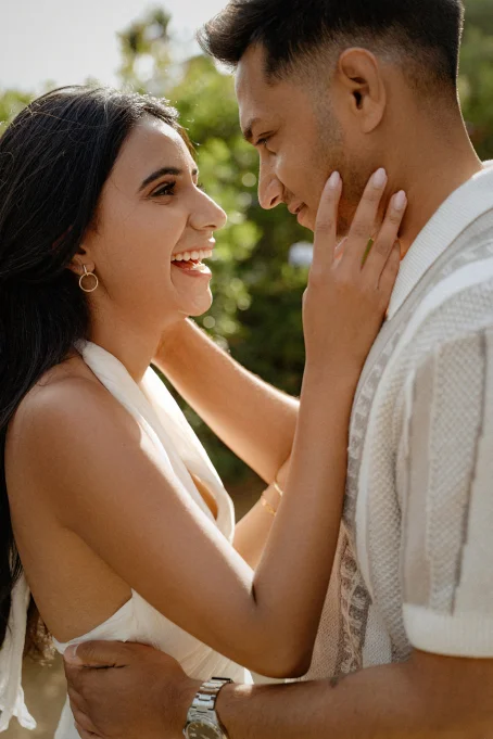 Joyful couple sharing an intimate moment during a romantic photoshoot at Marimurtra garden.