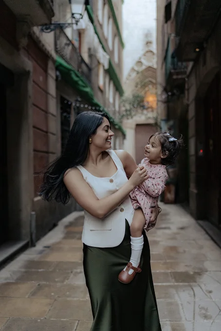 Mother and daughter share a joyful moment while exploring the charming Born area during a location photoshoot.