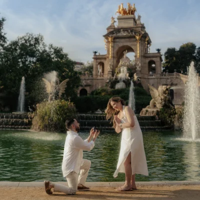 Romantic proposal at Park de la Ciutadella, couple sharing a joyful moment by the fountain, engagement photography.