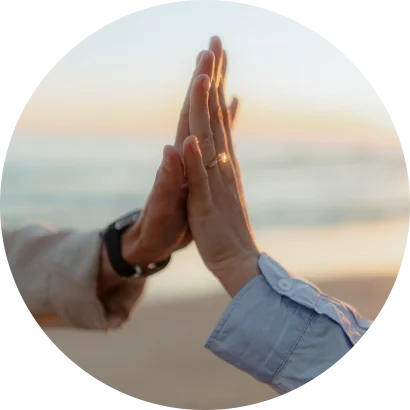 Couple sharing a joyful high five at sunset, engagement ring visible, captured during a surprise proposal in Barcelona.