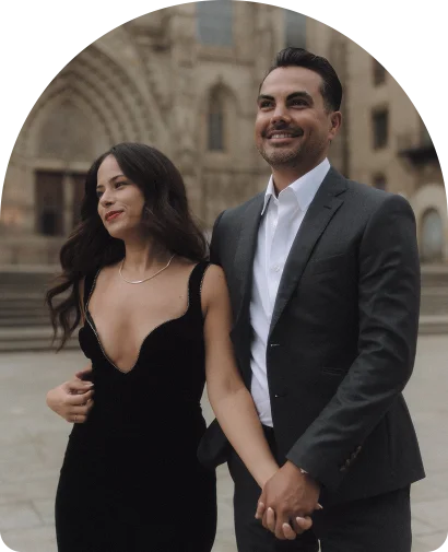 Smiling couple holding hands during an engagement photoshoot in Barcelona’s historic city center.