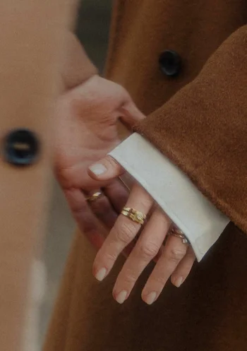 Close-up of two people gently holding hands during a Vacation Portraits photoshoot in Barcelona.