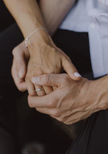 Couple holding hands during a Vacation Portraits photoshoot in Barcelona, capturing a tender and intimate moment.