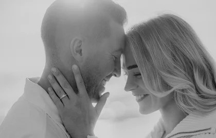 Couple sharing a joyful, intimate moment after a surprise proposal in Barcelona, captured in soft natural light.