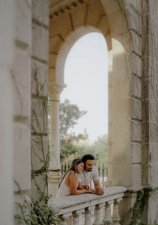 Couple sharing a quiet moment on a stone balcony during a Vacation Portraits photoshoot in Barcelona.