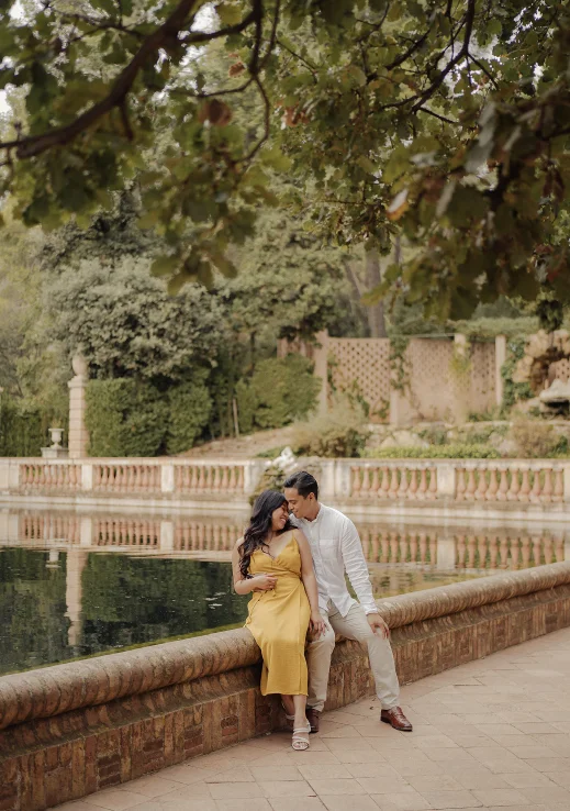 Couple sharing a tender moment by a pond in Barcelona during a Vacation Portraits photoshoot.