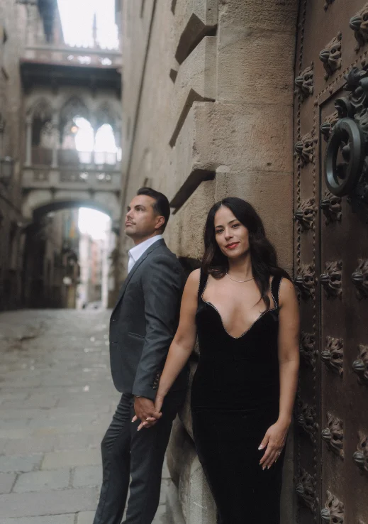 Elegant couple holding hands during an engagement photoshoot in historic Barcelona’s Gothic Quarter.
