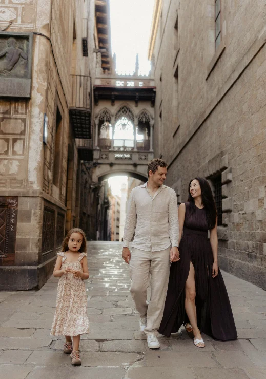 Family enjoying a Vacation Portraits photoshoot, strolling through a charming street in Barcelona’s Gothic Quarter.