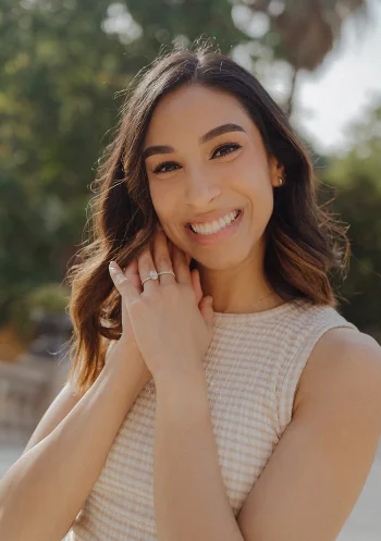 Joyful woman showing her engagement ring after a surprise proposal photoshoot in sunny Barcelona.