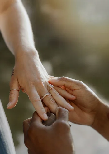Romantic surprise proposal in Barcelona, capturing the moment a ring is placed on a partner’s finger.