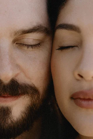 Close-up of a couple with eyes closed, capturing an intimate moment during a surprise proposal in Barcelona.