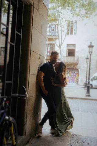 Couple shares an intimate moment during a surprise proposal photoshoot in the streets of Barcelona.