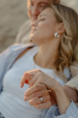 Engaged couple holding hands, sharing a tender moment during a Barcelona couples photoshoot.