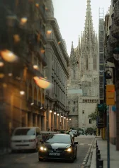 A romantic couples photoshoot in Barcelona, capturing love on a city street with the cathedral in the background.
