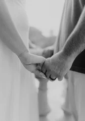 Couple holding hands during an engagement photoshoot, capturing a tender moment of connection and love.