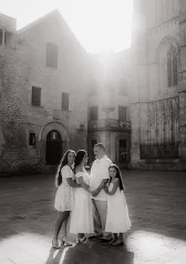 Family photoshoot in Barcelona historic square with soft sunlight